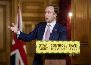 Matt Hancock talking in front of podium that says 'stay alert, control the virus, save lives'