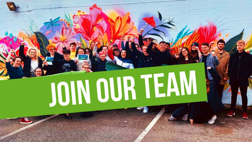 Join our team! img: young greens with fists in the air in front of colourful mural