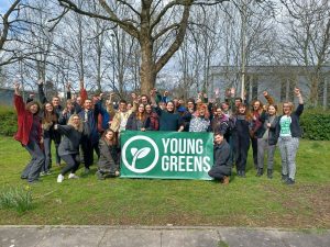 30 Under 30 Graduates from 2022 holding the Young Greens banner with their fists raised