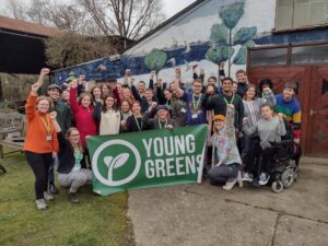 The 30 Under 30 participants stood in a group with the Young Greens banner
